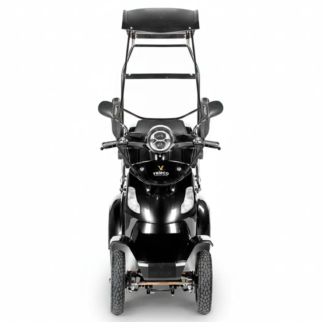 Vista frontal de scooter con techo mostrando el sistema de luces completo y espejos retrovisores dortomedical